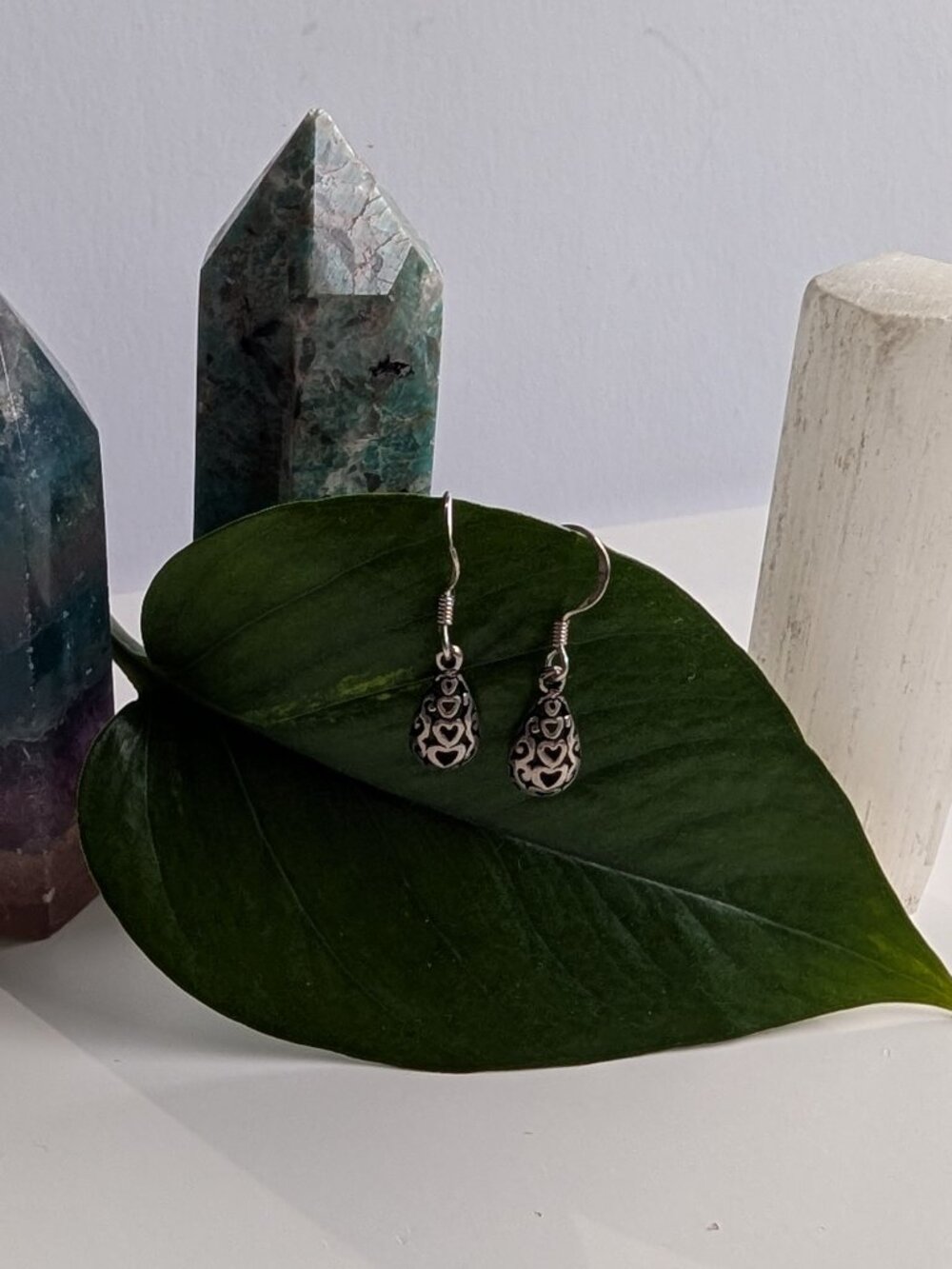 Women's vintage sterling silver teardrop dangle earrings with a heart filigree